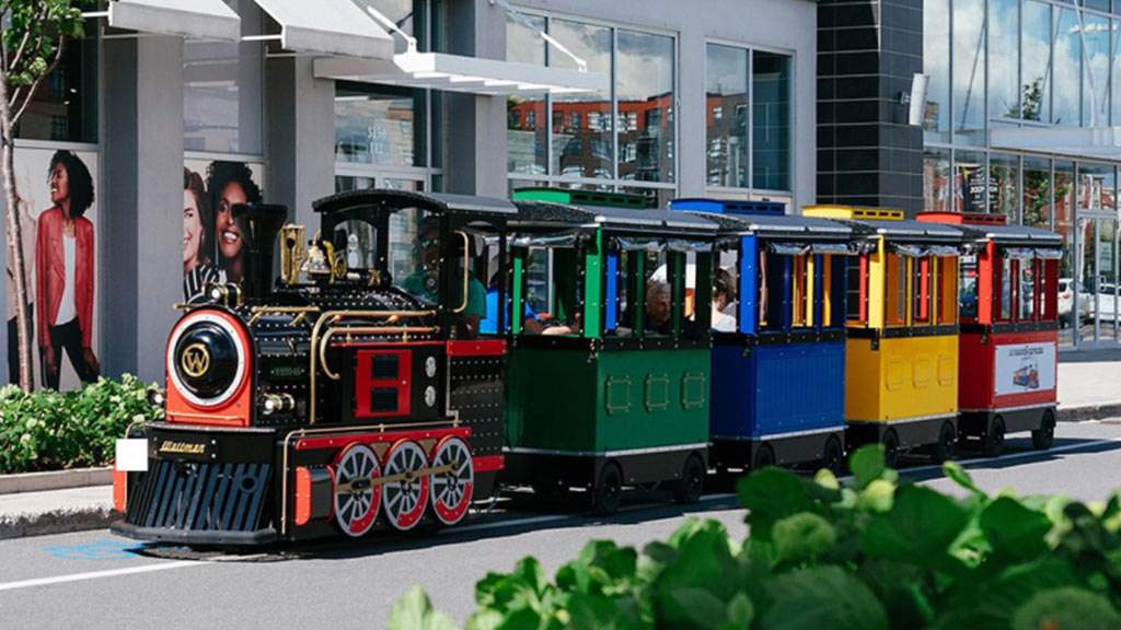 Trackless Wattman Maxi Express train giving rides inside a busy US shopping mall