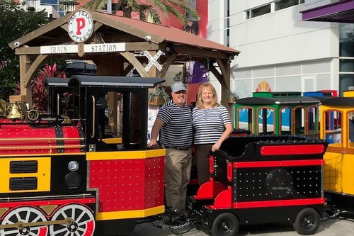 Bob Oglesby and Karen Oglesby with Pearl Express Wattman Mini Express trackless train at ICON Park Orlando