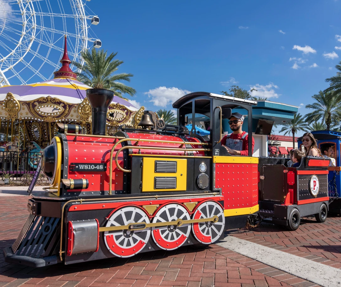 Pearl Express Train conductor operating a Wattman Maxi Express at ICON Park Orlando