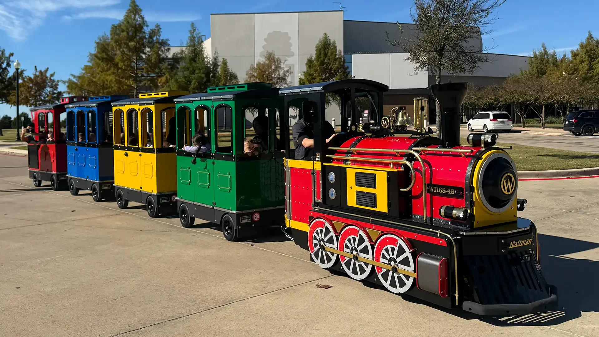 Wattman electric trackless train at a U.S. church campus event with families and children